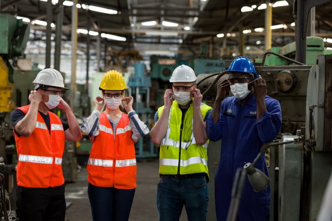 Group,Of,Diversity,Factory,Worker,Wearing,Face,Mask,Working,At